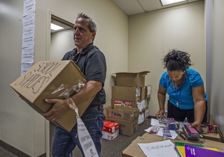 Newport News Shipbuilding employees Tommy Cragg and Stephanie White count and pack school supplies donated by fellow shipbuilders as part of the shipyard’s annual School Tools drive. The supplies were delivered to the social services departments of Newport News, Hampton and York County and the Boys & Girls Clubs of the Virginia Peninsula. Photo by John Whalen/HII