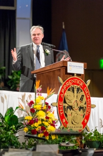 Sen. Tim Kaine, D-Va., addresses the 170 graduates at The Apprentice School’s commencement exercises. Kaine is a founder and co-chair of the Career and Technical Education (CTE) Caucus and served as the ceremony’s keynote speaker. Photo by Chris Oxley/HII Sen. Tim Kaine