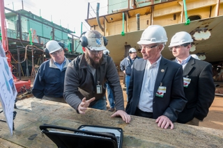 Aaron Wikle (left), a pipefitter at Newport News Shipbuilding, shows Rep. Joe Courtney how the shipyard is presenting work to shipbuilders in a visual environment with the goal of improving quality and cost performance. Photo by Chris Oxley/HII Rep. Joe Courtney visits Newport News Shipbuilding