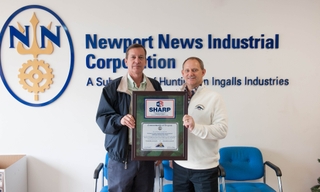 NNI Vice President Steve Napiecek (left) and Pete Diakun, Newport News Shipbuilding’s vice president of energy programs, presented NNI’s SHARP (Safety and Health Recognition Program) certification from OSHA at a year-end meeting with employees. Photo by Matt Hildreth/HII OSHA Recognizes Newport News Industrial