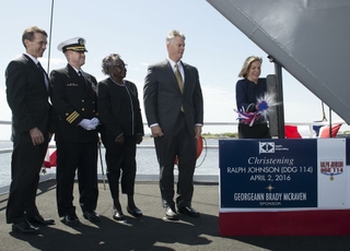 Ship Sponsor Georgeann McRaven christens DDG 114, the destroyer named for Medal of Honor recipient Ralph Johnson. Also pictured (left to right) are Assistant Secretary of the Navy Sean Stackley; Cmdr. Jason Patterson, the ship’s prospective commanding officer; Helen Richards, Ralph Johnson’s sister; and Ingalls Shipbuilding President Brian Cuccias. Photo by HII Ralph Johnson(DDG 114) is Christened