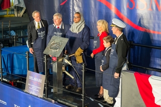 Ship Sponsor Dr. Jill Biden's initials were welded today onto a steel plate that will be permanently affixed to the submarine Delaware (SSN 791), symbolizing her lifelong relationship with the shipbuilders and crew. Pictured (from left) are Sen. Thomas Carper, D-Del., Newport News Shipbuilding President Matt Mulherin, Newport News Shipbuilding welder L.A. Britt, Biden and her grandson, Hunter Biden, and Delaware Commanding Officer Cmdr. Brian Hogan. Photo by Chris Oxley/HII Dr. Jill Biden's Initials