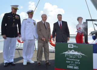 Ship Sponsor Bonnie Amos christens the amphibious transport dock Portland (LPD 27), accompanied by (left to right) U.S. Marine Corps Maj. Gen. Christopher Owens, director of the U.S. Navy’s expeditionary warfare division; Capt. Jeremy Hill, prospective commanding officer, Portland; Ted Waller, a World War II veteran who served on the first USS Portland (CA 33); and Brian Cuccias, president of Ingalls Shipbuilding. Portland is the 11th LPD built by Ingalls. Photo by Lance Davis/HII Portland (LPD 27) Christened