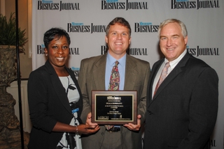 Ed Hagar (center) accepted the Mississippi Business Journal's Healthiest Workplace Award on behalf of Ingalls Shipbuilding on Wednesday. Hagar, Ingalls’ manager of compensation, benefits and HRIS, is pictured with Tami Jones, associate publisher of the Mississippi Business Journal, and Murray Harver, executive director of the Mississippi Business Group on Health. Photo by Bill Glenn/HII Ingalls Earns Healthiest Workplace Award