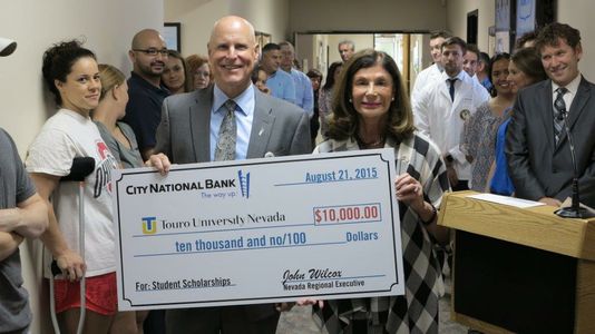 John Wilcox (l-r), Nevada regional executive of City National, presents Shelley Berkley, CEO and senior provost of Touro, with a $10,000 donation for the University’s Scholarship Program.