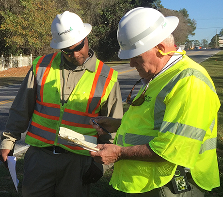 Duke Energy arborist Cordy Williamson (left) studies a customer’s magnolia tree with one of Duke’s tree-trimming contractors in Florence, S.C. The 50-year-old tree was touching a power line and needed pruning. Williamson always advises tree trimmers to treat a customer’s tree like it was their own.