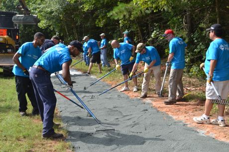 Employee volunteer groups construct a walking track in South Boston, Va.