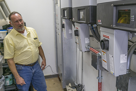 Bruce Wood of Sunstore Solar shows off the interior installation that control the solar panels. 10-PS-SC_Solar-460_309