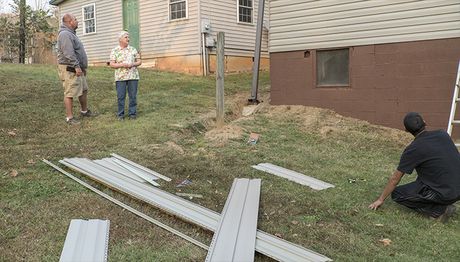 Butch Zadio speaking to Janet Lutz as, his crew from Green Horizons Innovators finished improvements her home in Hickory. 06-HelpHome-700