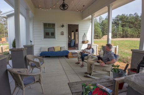 Gernon Harvey and his wife, KK, lounge in the breezeway area between their main house and the tiny bunkhouse. dke-gernonharvey-24_25788029381_o
