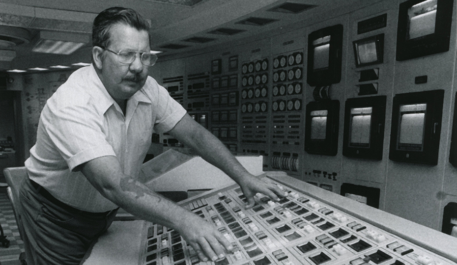 From the Duke Power collection. What is this man doing, and where? Man at controls BW 0516