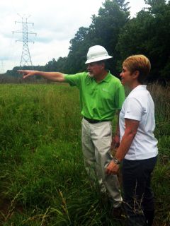 Jeff Racey of Duke Energy and Becky Langer of Bayer inspect the site in Durham, N.C. Bees(2)