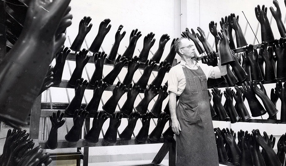 This looks like it's from a scifi flick titled "Man of 1,000 Gloves." This photo was shot at Public Service of Indiana headquarters in 1951. The caption says Mr. Gadby inspects puffer gloves used by linemen. CYID041