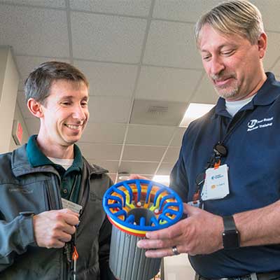 Michael Bowen, left, tells Christopher Rop how water flows for cooling into this model of a generator. 3D-23.BOWEN.ROP