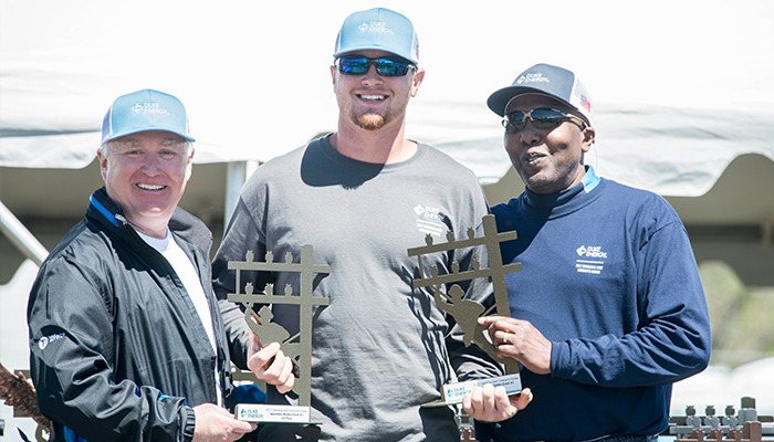 Drew Caison accepts his awards from Keith Johnson, left, and XX, right. 20170413CaisonFamilyLinemen_1