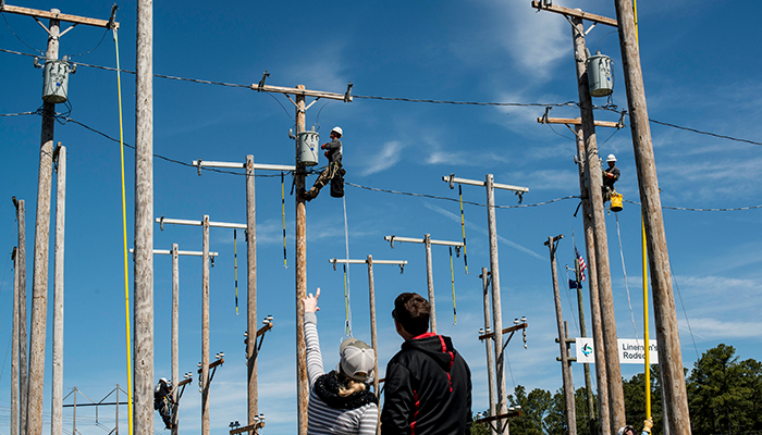 Spectators watch Drew Caison compete at the Carolinas East Lineman's Rodeo. 20170413CaisonFamilyLinemen_3