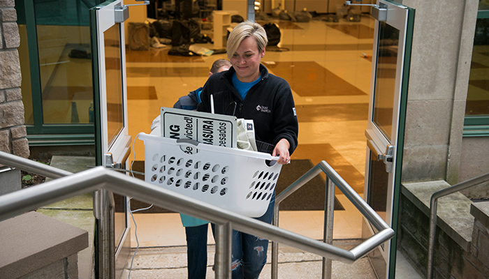 Duke Energy employee Kacie Carroll helps gather items at a residence hall for the Hoosier to Hoosier Community Sale. 20170523HoosierCommunitySale_700_1