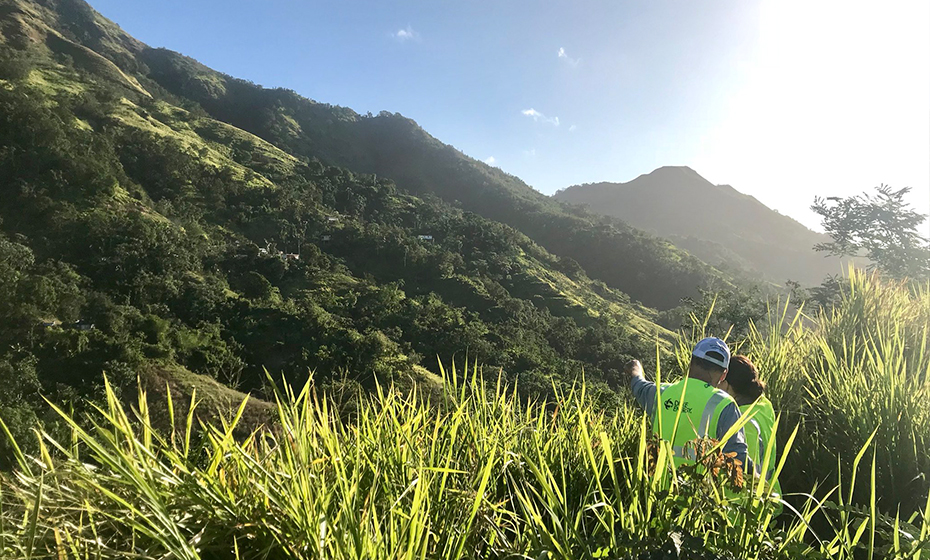 Workers survey a project in the mountains. 2018-0214-Mosier-Puerto-Rico-930-4