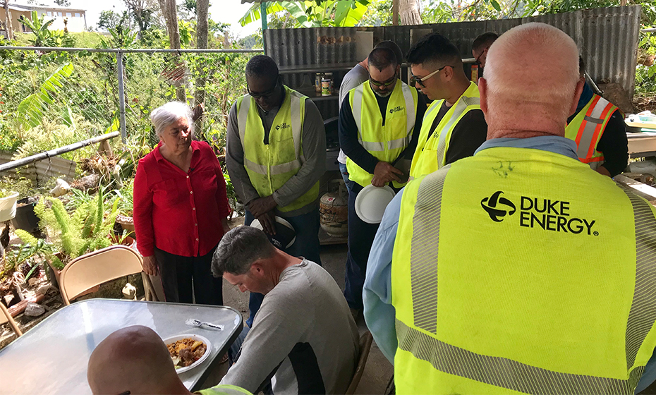 A Puerto Rican woman prays with crews over the lunch she made for them as a thank you. 2018-0215-Mosier-Puerto-Rico-2