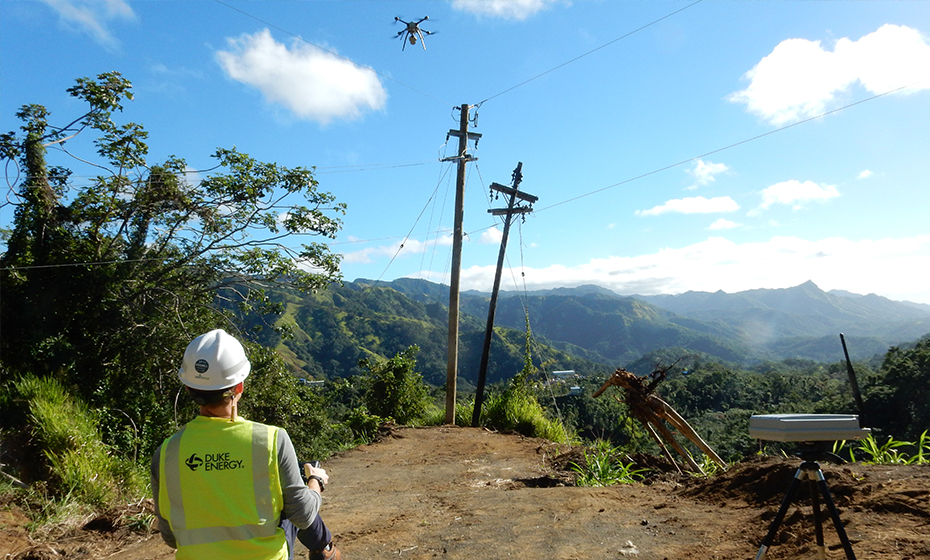 Bryan Williams pilots the drone as it puls a cord from one pole to the next. 2018-0215-Puerto-Rico-Drones-1