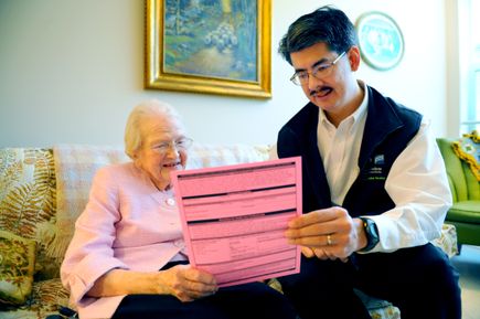 Erik Fromme, M.D., with a patient, reviewing a POLST form.(OHSU) POLST consultation
