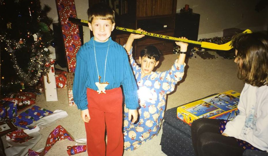 Brad Black (in front) and his brother opening Christmas presents Brad Black
