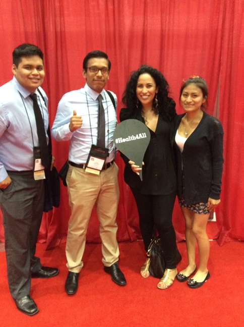 Luis Melchor and friends posing for the camera with the #Health4All pin drop.