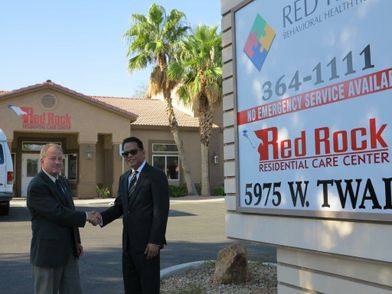 Jeff Jarvis (l-r) from City National and Srinivasan Ganti stand in front of the Red Rock Residential Care Center